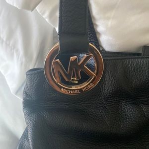 Black leather Michael Kors. Gently used. Very clean.